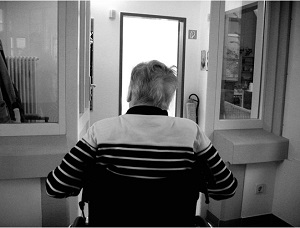 The back of an elderly patient's head in a wheelchair. 