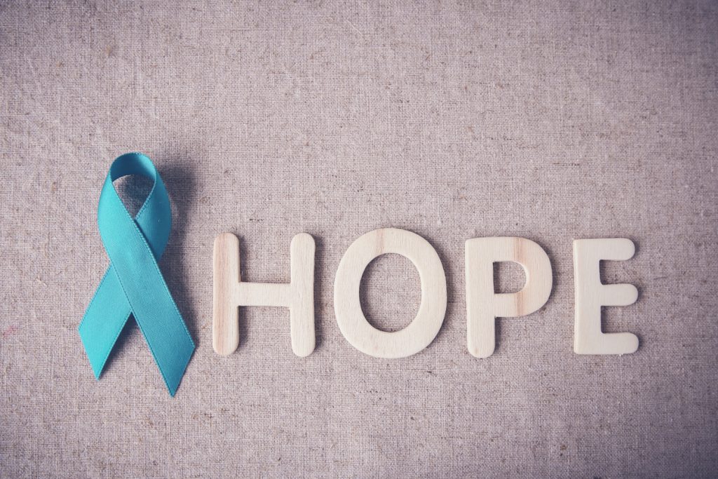 Teal ribbon representing victims of sexual assault next to the word "hope"