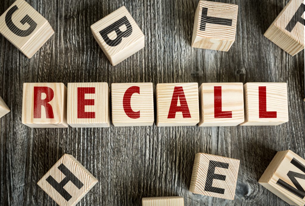 Wooden blocks with letters spelling out the word "recall"