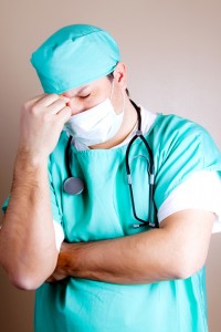 frustrated-surgeon-holding-bridge-of-nose-wt-johnson