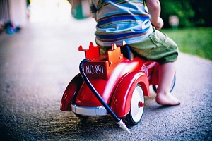 young kid playing with toy outside