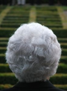 older woman facing a staircase