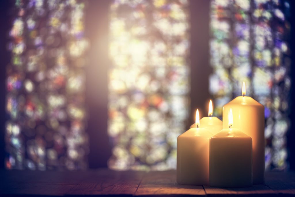 Candles burning inside of a church