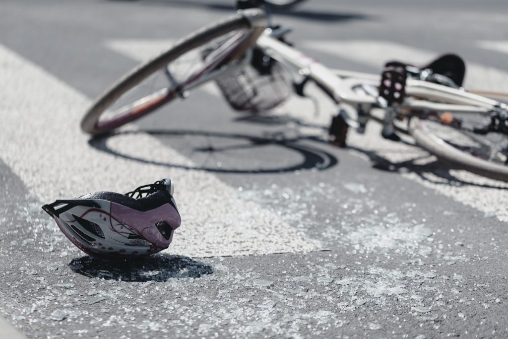 Helmet and bicycle laying in the street after accident