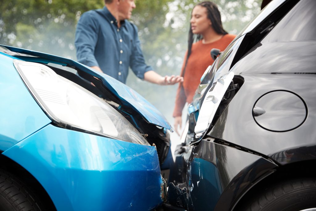 Two people arguing over a car accident