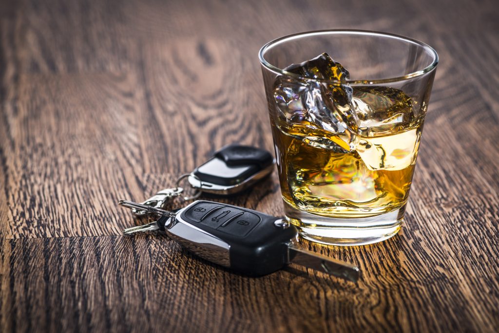 Car keys next to an alcoholic drink