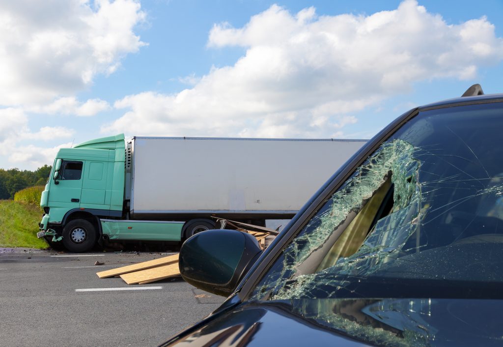 Car with broken windshield after a truck accident