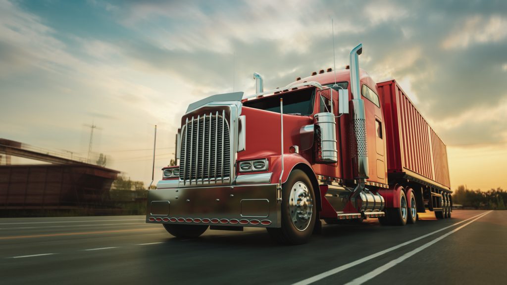 A red semi-truck on the road